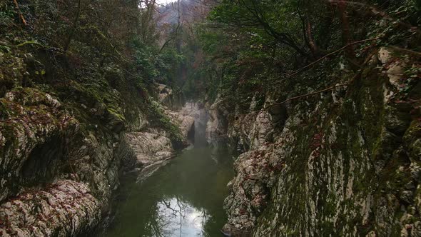 Flying Over a River Through a Narrow Canyon with White Rocks Sochi alt