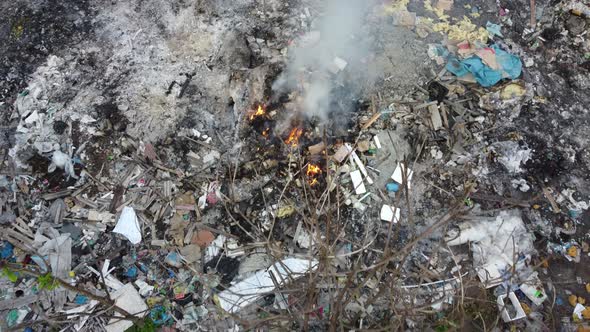 Aerial view open burning rubbish cause smoke release created air pollution. alt