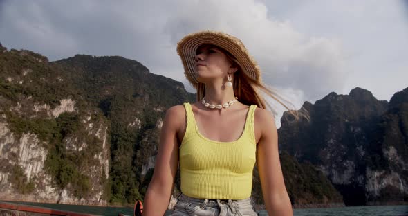 Tourist in Straw Hat Looking Up Enjoying the Lake and Boat Ride on a Summer Day alt