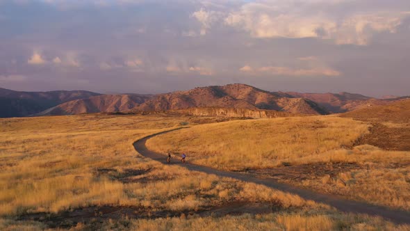 Two Cyclists Cycling on a Trail in North Table Mountain Park alt