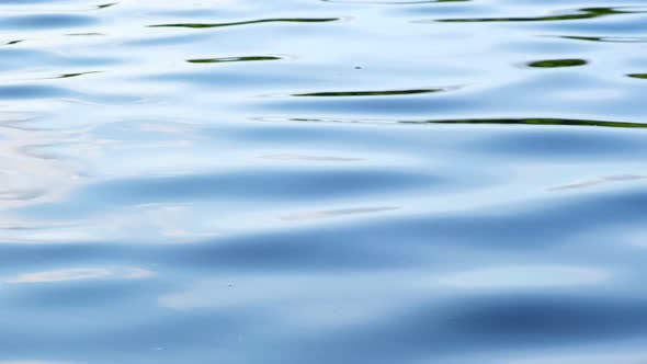Ripple waves on blue lake water background.