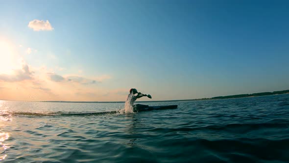 A Lake with a Male Boater Crossing It on a Canoe alt