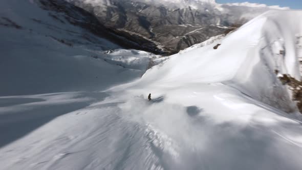 FPV Drone Extreme Snowboarder Freeride on Snowboard Jumping Drop on Snow alt