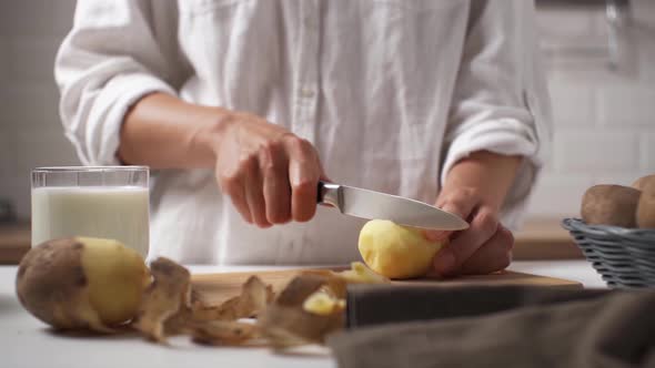 Beautiful Girl Cook Cuts Raw Potatoes For Cooking Vegetable Food, Cutting Potatoes On A Wooden alt