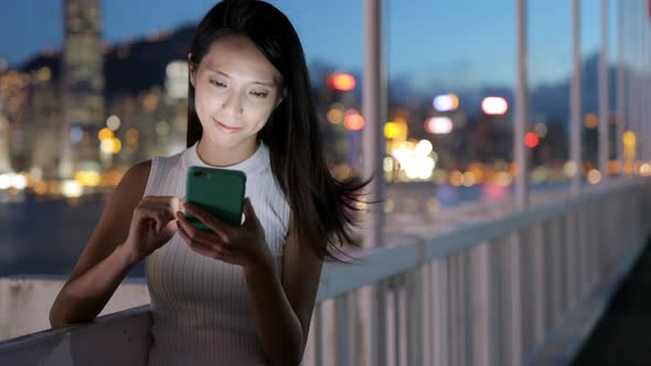 Woman use of mobile phone at night alt