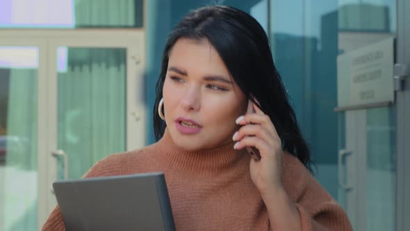 Portrait Confident Young Businesswoman Walking Down Street Backdrop Office Building Talking on alt