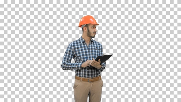 Young engineer in helmet inspecting construction, Alpha Channel