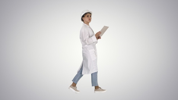 Young technician inspecting and taking necessary notes alt