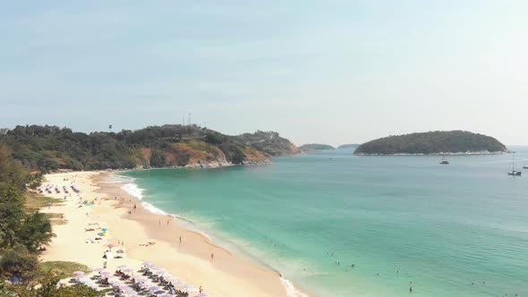Reveal of tranquil Nai Harn bay in southern Phuket, Thailand - Aerial wide Fly-over shot alt