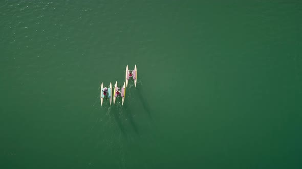 Aerial view people on water bike pedal boats in Greece. alt