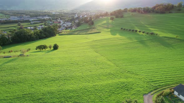 Aerial Landscape View of Ideal Green Fields in Liechtenstein Alps at Sunset alt