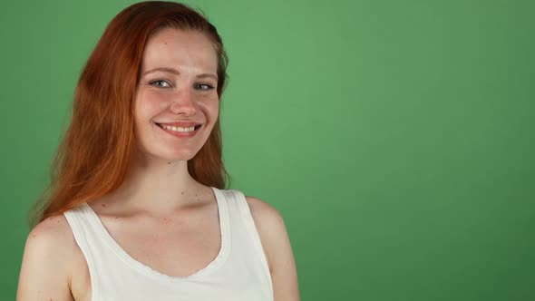 Gorgeous Red Haired Woman Smiling Presenting Copy Space 1080p alt