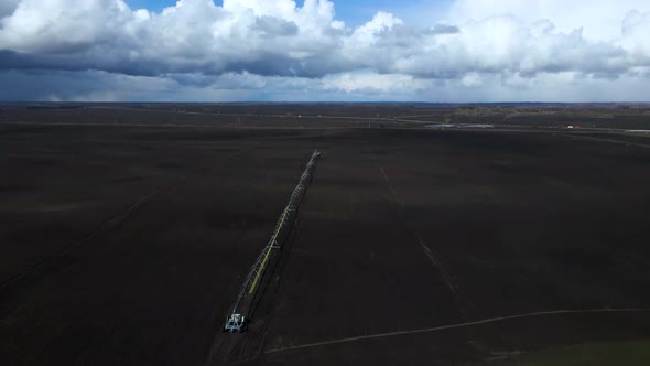 Aerial drone view drip irrigation watering system in agricultural farm field alt