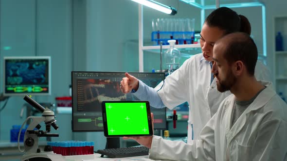 Professional Chemists Working on Tablet with Chroma Key Screen alt