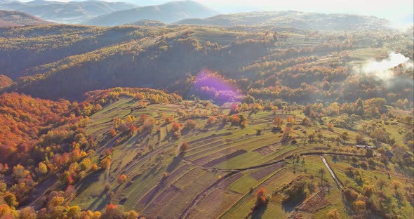 A View From a Height of a Yellow Forest Mountain Valley Surrounded By High Mountains alt