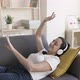 Happy Young Adult Woman Listening to Music and Dancing While Relaxing at Home - VideoHive Item for Sale