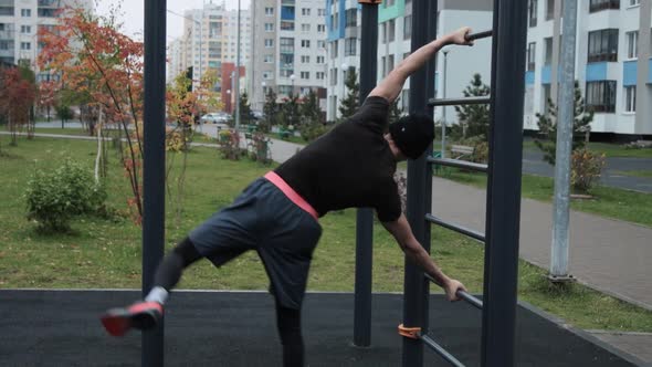 Muscular man training outdoors on sports field