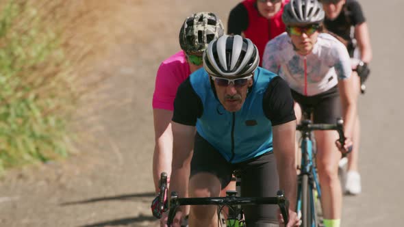 Group of cyclists on road.  Fully released for commercial use.