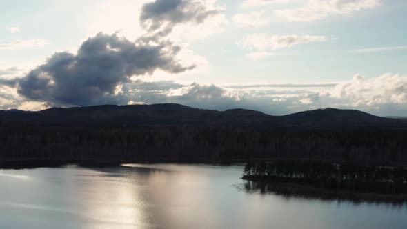 Aerial View of the Natural Landscape Forest on the Lake Shore at Sunset alt
