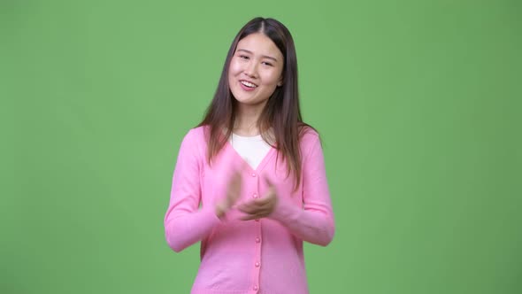 Young Beautiful Asian Woman Clapping Hands