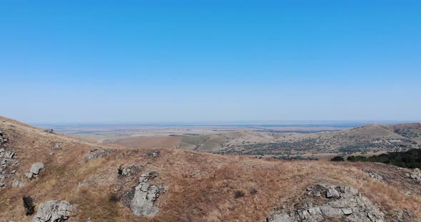 Craggy Mountain Range Of Macin, Reveal Oak Forests On Foothill On A Sunny Day alt