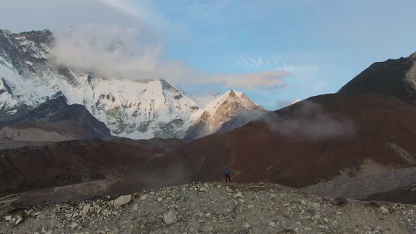 Lhotse South Face Mountain and Hiker Man at Sunset. Himalaya, Nepal, Aerial View alt