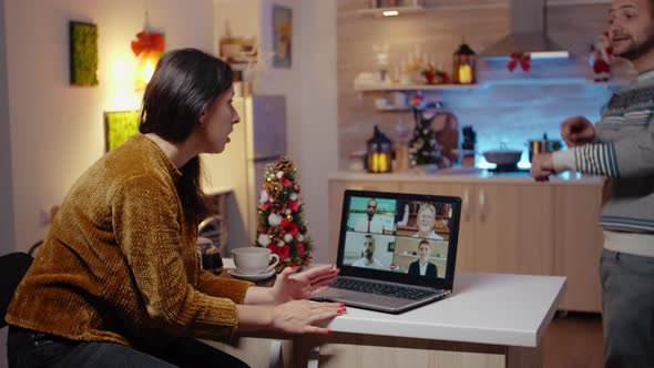 Business Woman Using Video Call on Laptop Working on Christmas Eve alt