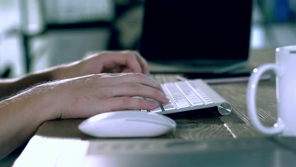 A Caucasian Male Typing on a Wireless Keyboard 20 alt
