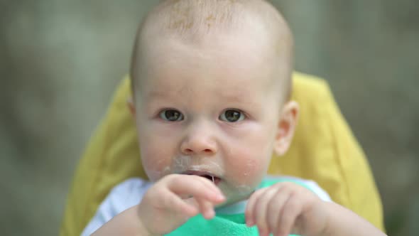 Happy Baby Boy Sitting in Highchair at Home alt