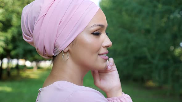 Fashionable Young Woman in Hijab Turns Head and Smiles alt