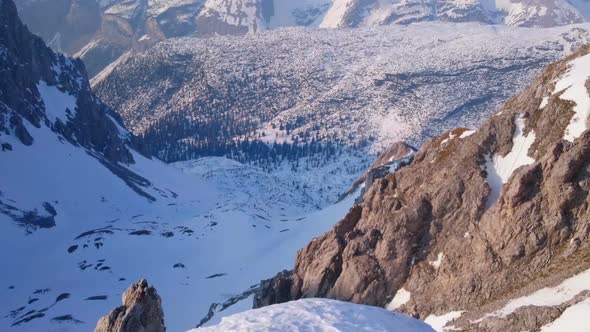 Magnificent Horizontal Pan of Snowy Mountain Range, Trees in Beautiful Valley alt