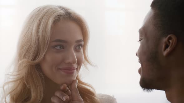 African American Husband Touching Wife's Chin And Kissing Her Indoors alt