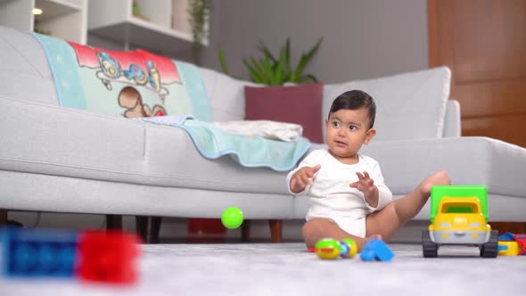 Baby funny posture and gaze. alt