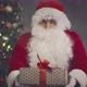 Portrait of Santa Claus with Christmas Gift Near Decorated Tree - VideoHive Item for Sale