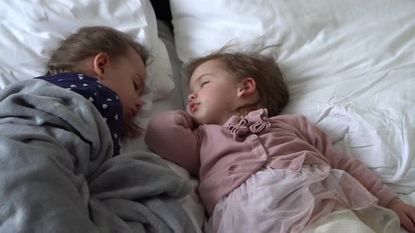 Authentic Two Cute Little Girls Sister Sleeping Sweetly Together In Comfortable White Bed