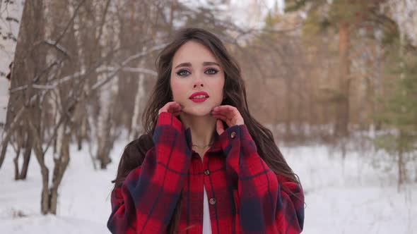 Charming Female with Long Hair Walking in Snowy Forest