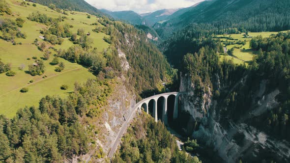 Landwasser Viaduct in Swiss Alps in Summer Aerial View on Green Mountain Valley alt