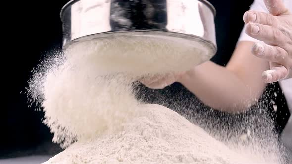 Female Hands Sifting Flour
