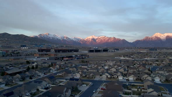 Silicon Slopes in Lehi, Utah with office buildings and a suburban community below the snow-capped mo alt