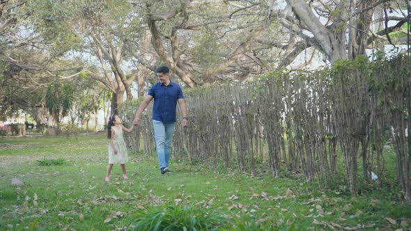 Dad and Daughter Walking in the Park alt