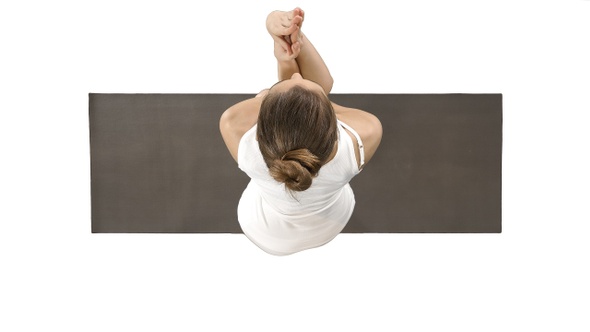 Attractive girl standing in the balancing yoga pose Garudasana alt