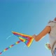 Low Angle Video - Girl Plays with Kite That Flies High in Blue Sky - VideoHive Item for Sale