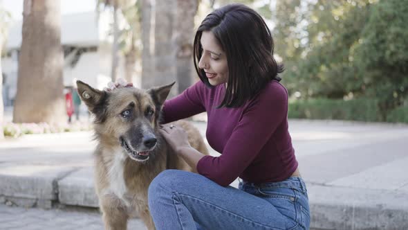 Beautiful woman petting dog alt