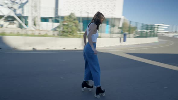 Young Darkhaired Woman in Jeans and White Top Roller Skates By Marina alt