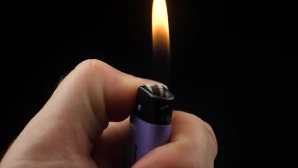 Slow Motion Video of Using a Lighter at Night with Sparkles and Fire alt