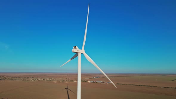 Aerial View of Autumn Countryside with Wind Turbines and Agricultural Fields on Sea Coast Background alt