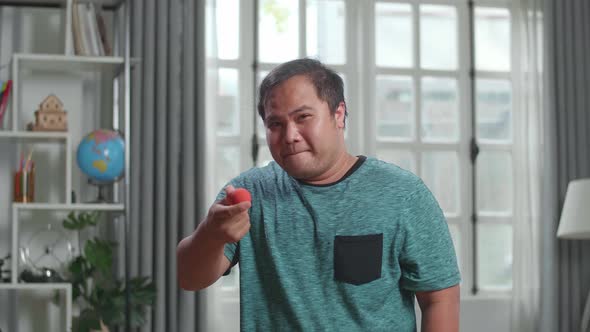 Asian Man Blogger Shoots Video Content For Social Networks, Magician With Red Ball alt