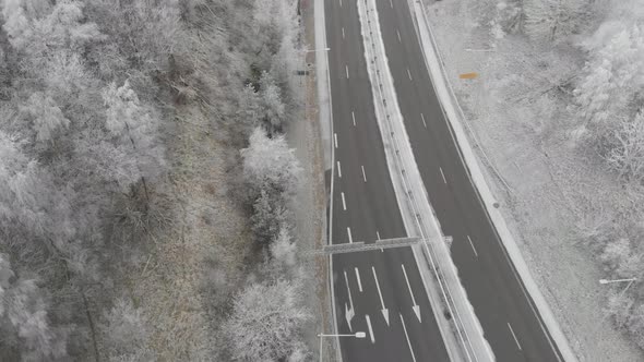Country Road With Single Cars Driving During Winter Low Aerial