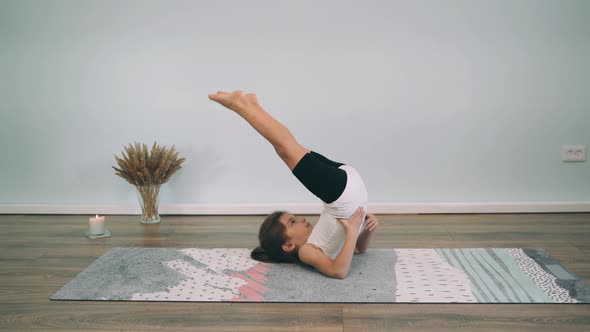 Caucasian Girl Does Yoga Gymnastic Exercises Online Child Trains Yoga Online Family Sport Legs Up alt