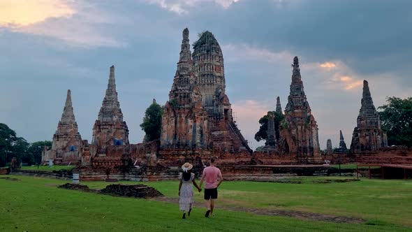 Men and Women with Hat Tourist Visit Ayutthaya Thailand at Wat Chaiwatthanaram During Sunset alt